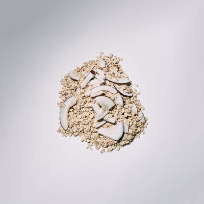 Pile of dried coconut pieces on a light gray background